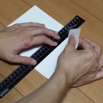 定規で紙を切っている最中の様子